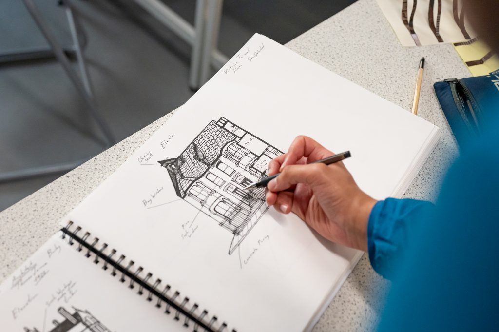 Design student sketching in a sketch book